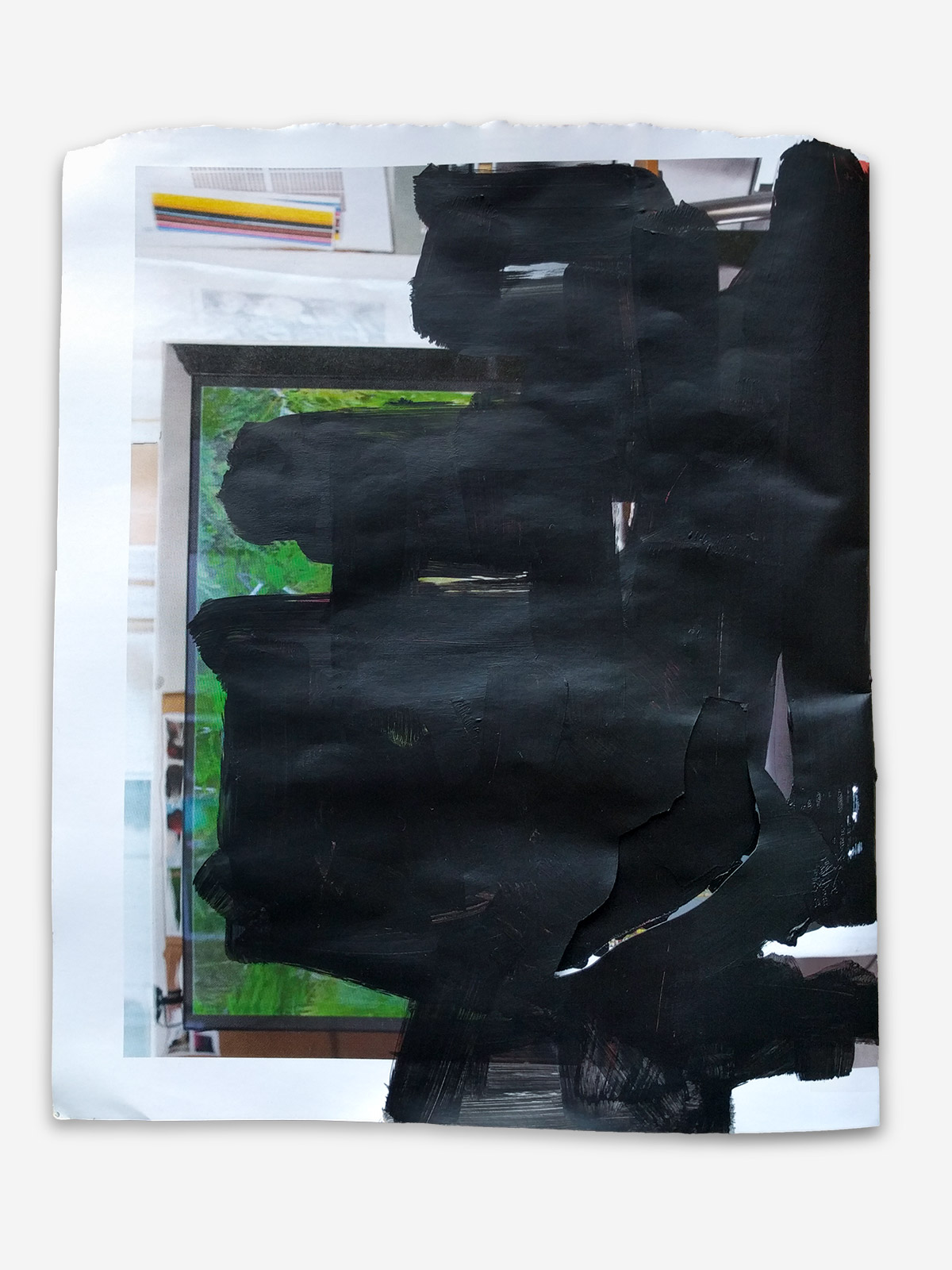 Black paint scribble on glossy magazine page. 